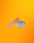 An orange silicone finger brush with a textured, raised grip on one end, shown next to its clear plastic storage case against a vibrant orange-to-yellow gradient background.
