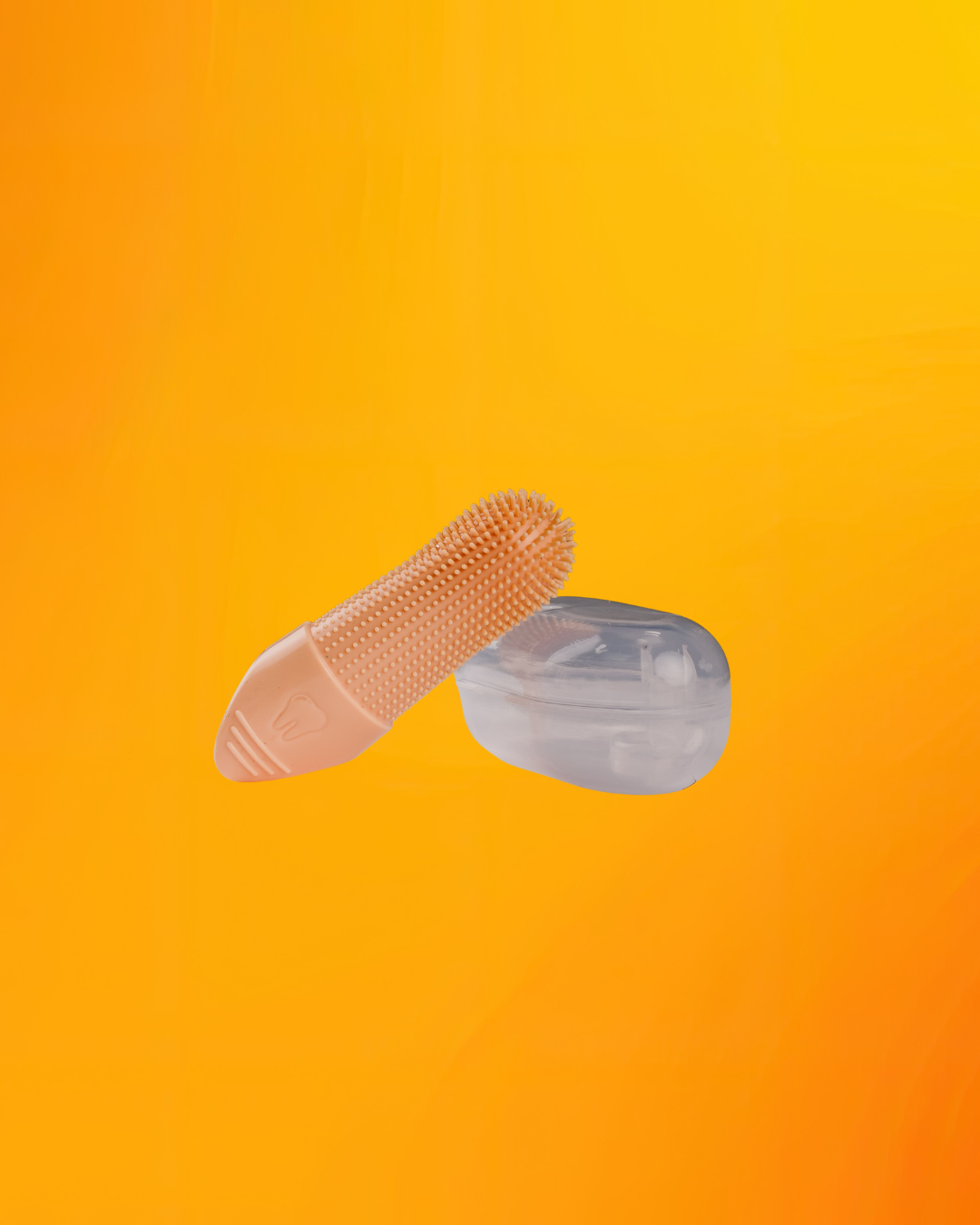 An orange silicone finger brush with a textured, raised grip on one end, shown next to its clear plastic storage case against a vibrant orange-to-yellow gradient background.