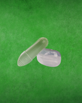 A light green silicone finger brush with a textured, brush-like surface and a translucent clear silicone case, shown against a textured green background.